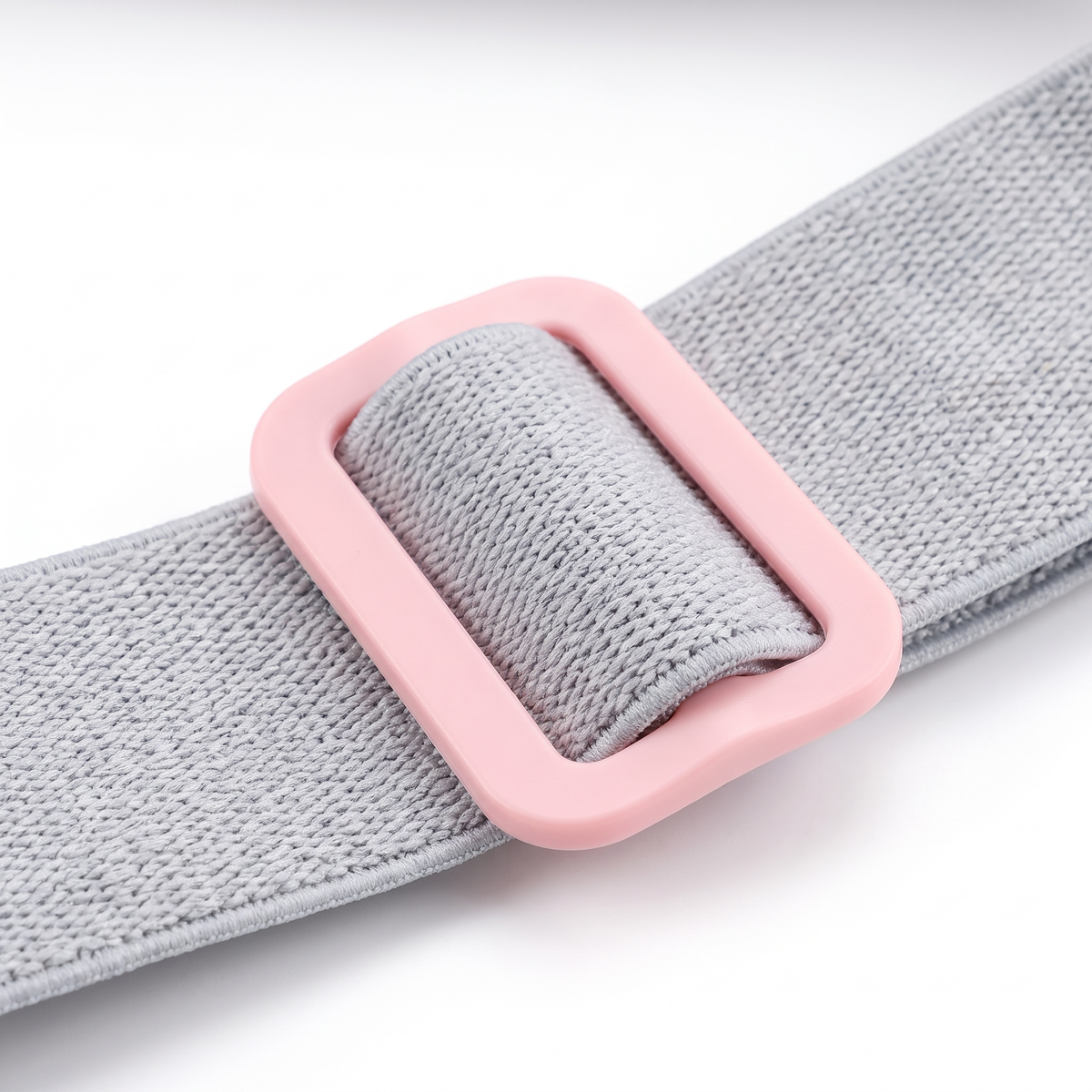 Close-up of the Kalmi belt grey elastic strap and pink buckle