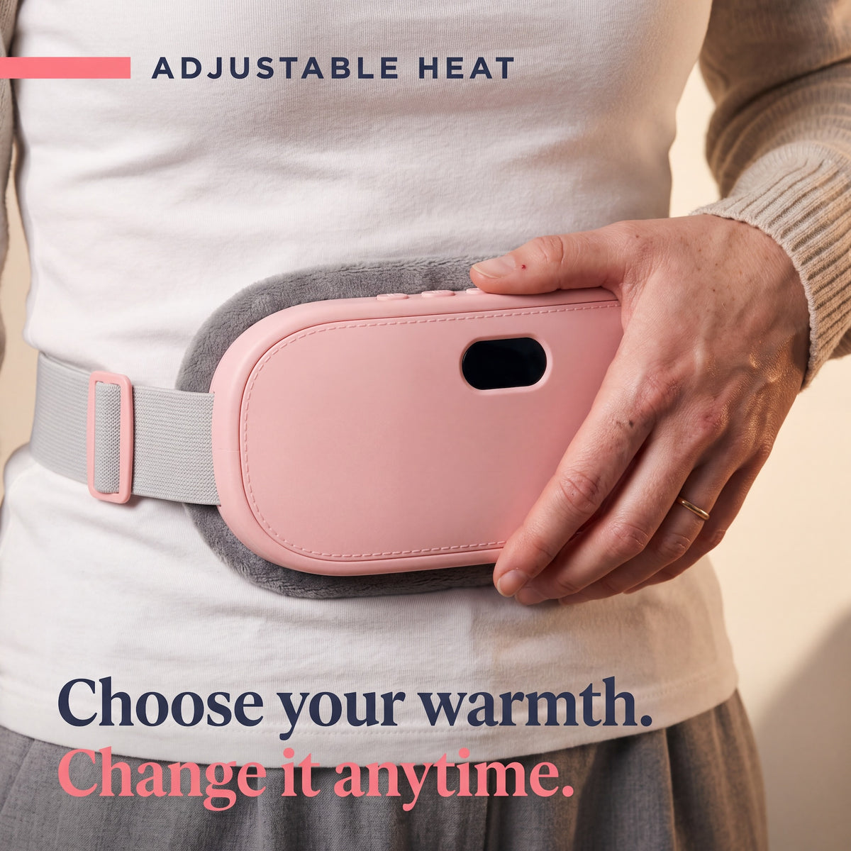 Woman adjusting the heat on the Kalmi belt worn around her lower abdomen